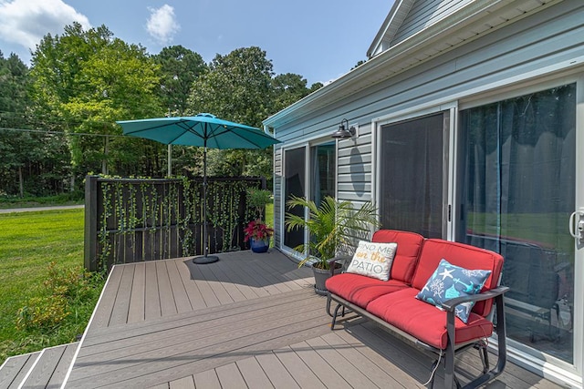 wooden terrace featuring a lawn