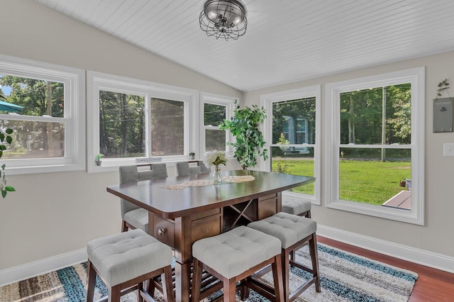 sunroom / solarium with a chandelier, electric panel, and vaulted ceiling