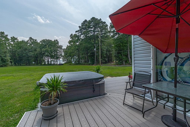 wooden terrace with a yard and a hot tub