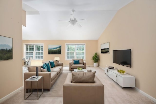 carpeted living room with ceiling fan and vaulted ceiling