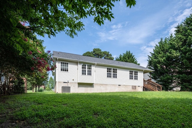 back of property with a yard and cooling unit