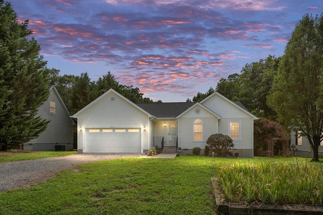 single story home with a yard and a garage