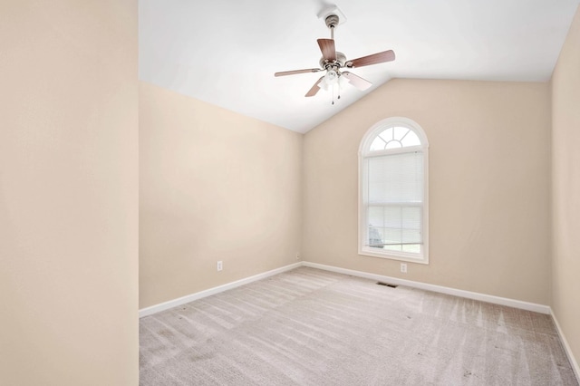 unfurnished room with ceiling fan, lofted ceiling, and light carpet