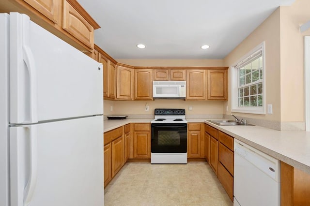 kitchen featuring white appliances and sink