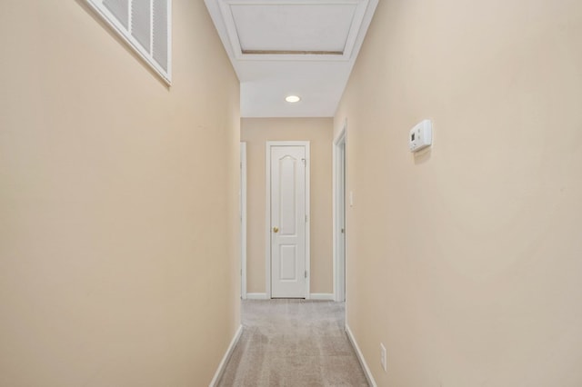 hall with light colored carpet