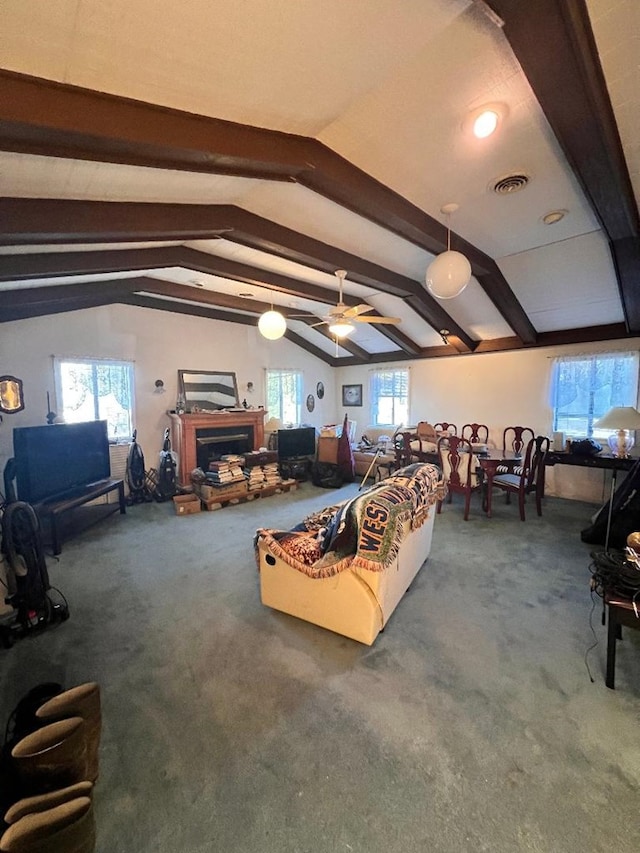 living area featuring carpet floors, visible vents, a fireplace, and lofted ceiling with beams