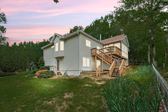 1753 N Independence Dr, Montross, VA 22520 - back of property at dusk featuring stairway, a lawn, and a deck