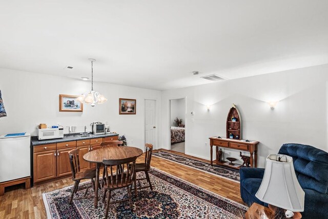 1753 N Independence Dr, Montross, VA 22520 - dining room with light wood-style floors and a chandelier