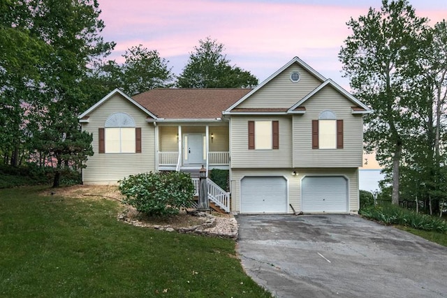 1753 N Independence Dr, Montross, VA 22520 - ranch-style house with asphalt driveway, a porch, stairway, a garage, and a yard