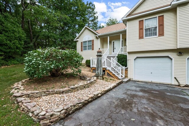 1753 N Independence Dr, Montross, VA 22520 - view of front of house with stairs, asphalt driveway, a garage, and a porch