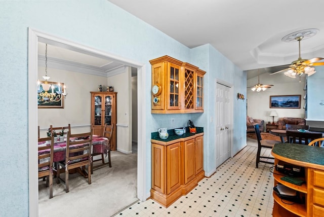 1753 N Independence Dr, Montross, VA 22520 - kitchen with crown molding, glass insert cabinets, a chandelier, ceiling fan, and brown cabinets