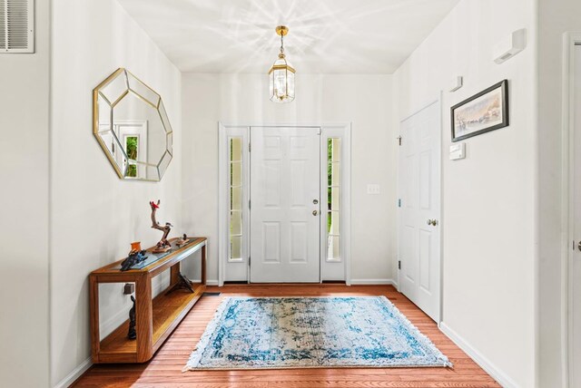 1753 N Independence Dr, Montross, VA 22520 - entryway with wood finished floors, a chandelier, and baseboards