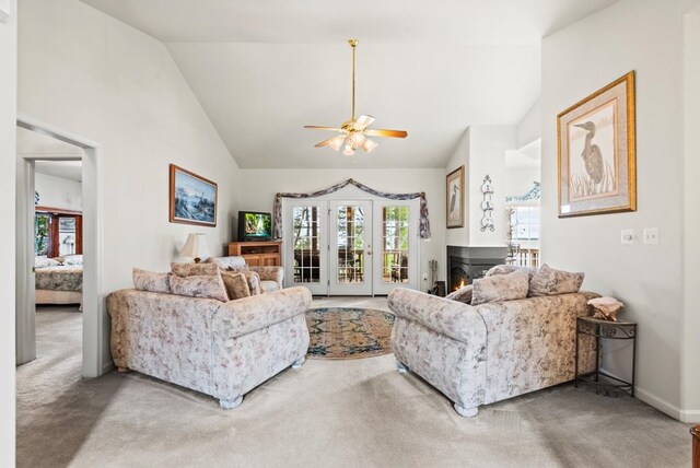1753 N Independence Dr, Montross, VA 22520 - living area with carpet floors, ceiling fan, a warm lit fireplace, high vaulted ceiling, and baseboards