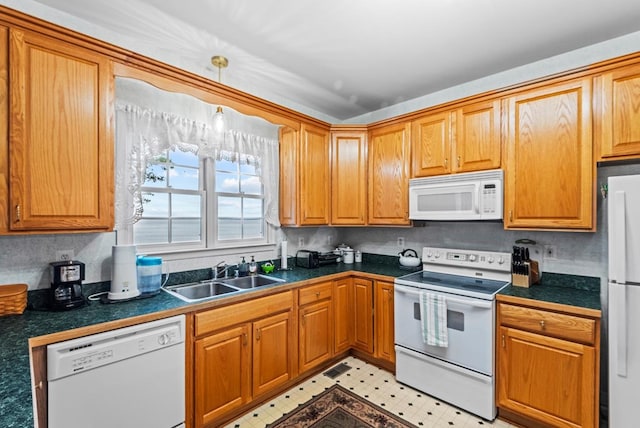 1753 N Independence Dr, Montross, VA 22520 - kitchen featuring white appliances, a sink, brown cabinetry, and hanging light fixtures