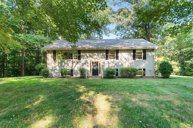 raised ranch with a front lawn