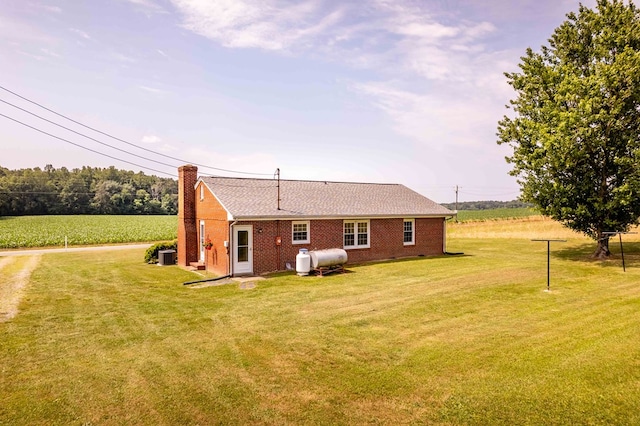 192 Morattico Rd, Lancaster, VA 22503 - rear view of property featuring a yard, brick siding, a chimney, and a shingled roof