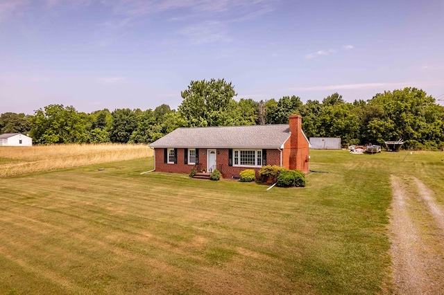 192 Morattico Rd, Lancaster, VA 22503 - view of front of home with a chimney, a front lawn, and brick siding