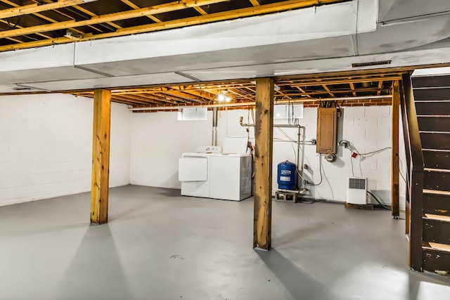 192 Morattico Rd, Lancaster, VA 22503 - basement featuring washer and dryer, a water pressure tank, and concrete block wall