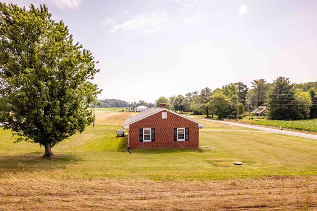192 Morattico Rd, Lancaster, VA 22503 - view of side of home featuring a lawn, brick siding, and a chimney