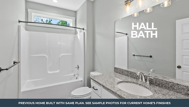 full bathroom featuring toilet, vanity, and bathing tub / shower combination