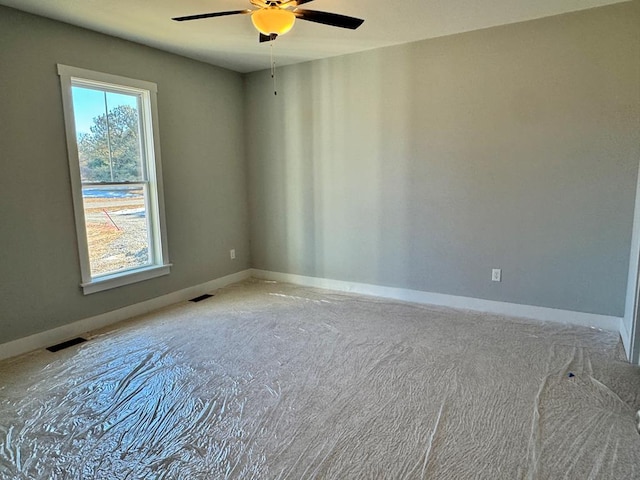 spare room with ceiling fan and a healthy amount of sunlight