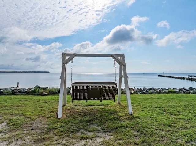 view of community featuring a water view and a lawn