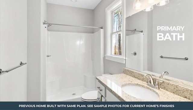 bathroom featuring walk in shower, vanity, toilet, and a wealth of natural light