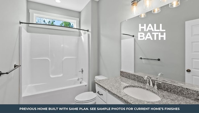 full bathroom featuring vanity, shower / bathing tub combination, and toilet