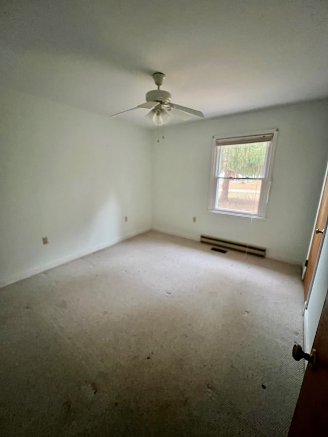 carpeted empty room featuring ceiling fan and baseboard heating