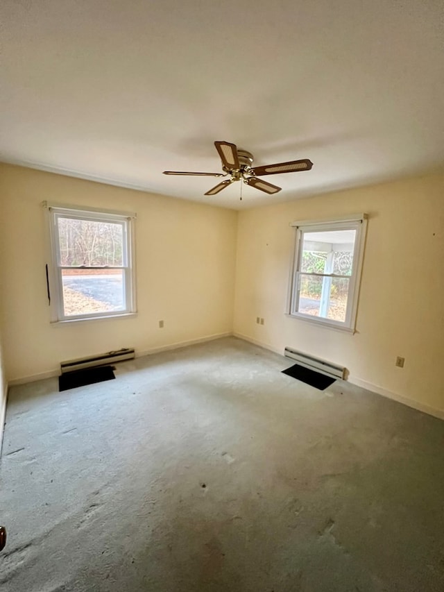 carpeted spare room featuring a wealth of natural light, a baseboard heating unit, and ceiling fan