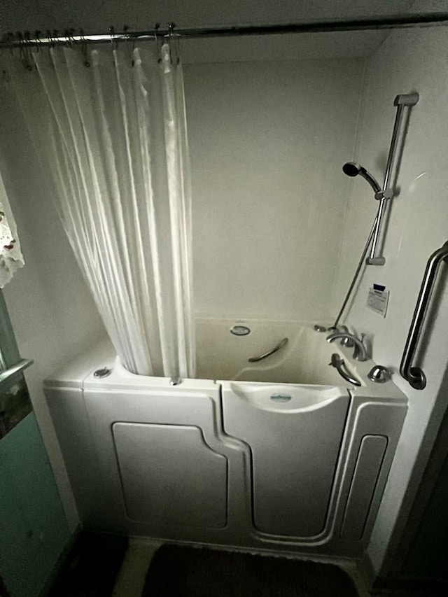 bathroom with shower / bath combination with curtain