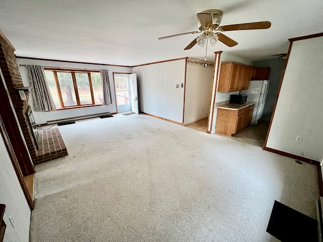 unfurnished living room featuring ceiling fan, light colored carpet, and a brick fireplace