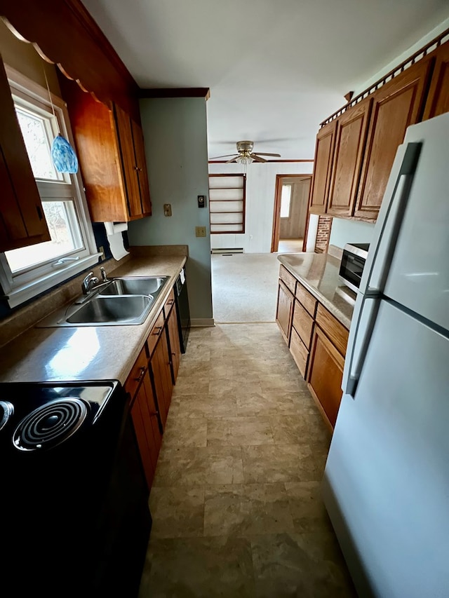 kitchen featuring black appliances, ceiling fan, and sink