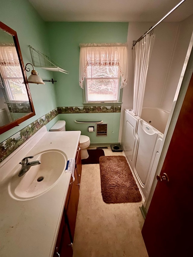 full bathroom featuring washer / dryer, vanity, shower / bath combo, and toilet