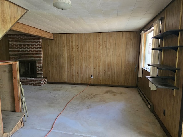 309 Riverview Dr, Heathsville, VA 22473 - unfurnished living room featuring wood walls, a fireplace, baseboard heating, and unfinished concrete flooring