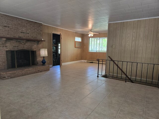309 Riverview Dr, Heathsville, VA 22473 - unfurnished living room with a fireplace, wood walls, baseboard heating, ceiling fan, and ornamental molding