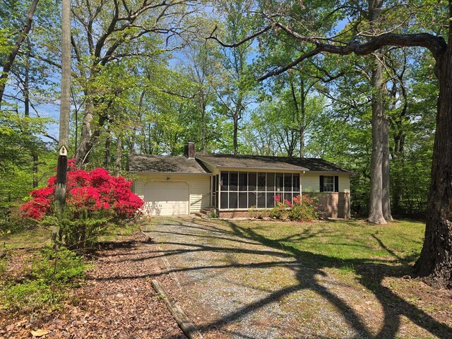 309 Riverview Dr, Heathsville, VA 22473 - exterior space featuring a sunroom, driveway, a chimney, and a garage