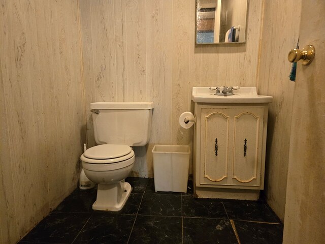 309 Riverview Dr, Heathsville, VA 22473 - bathroom with a sink, toilet, tile patterned floors, and wood walls
