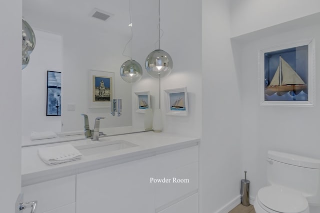 bathroom featuring vanity and toilet