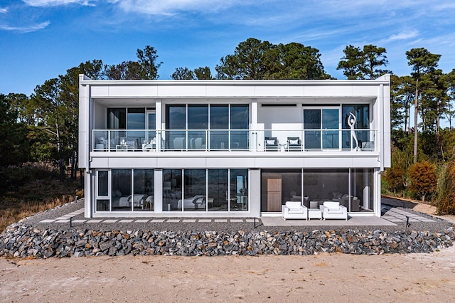 back of house featuring an outdoor living space and a patio