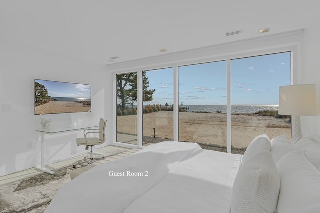 bedroom featuring access to exterior and a water view