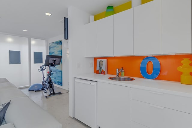 kitchen featuring dishwasher, white cabinets, and sink