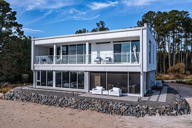 back of property with a patio area and central AC