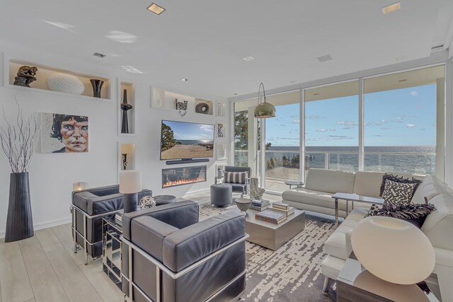 living room with light hardwood / wood-style flooring and expansive windows