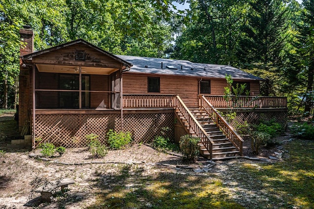 back of house with a wooden deck and a sunroom