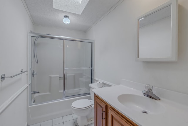 full bathroom with a skylight, tile patterned flooring, toilet, enclosed tub / shower combo, and a textured ceiling