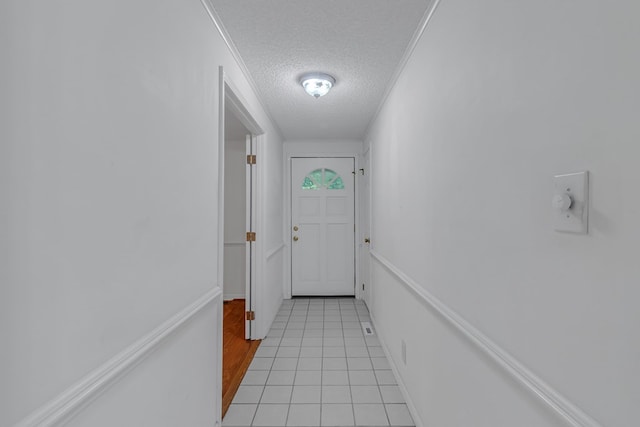 doorway featuring light tile patterned floors and a textured ceiling