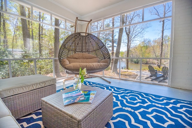 sunroom featuring plenty of natural light and a water view