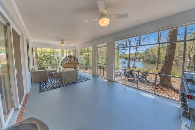 unfurnished sunroom with a water view and ceiling fan