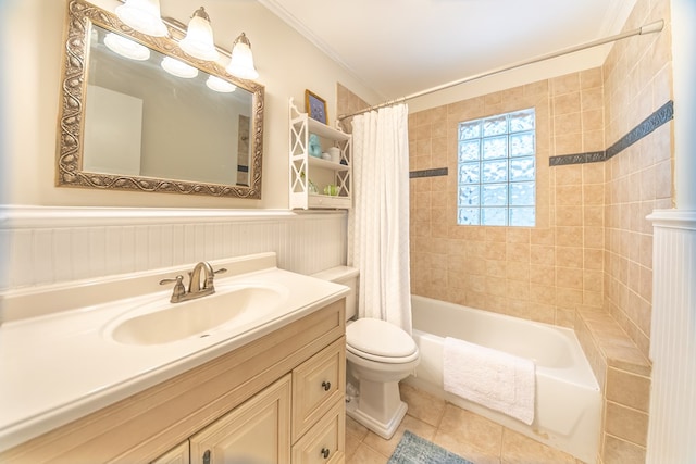 full bathroom with toilet, shower / bath combo with shower curtain, tile patterned flooring, ornamental molding, and vanity